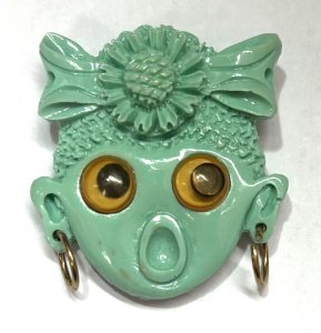 Lot 164 - Vintage pale green plastic novelty Brooch - female face with hoop earr